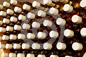 Bottles in a row at wine cellar. Stacked up wine bottles in the cellar