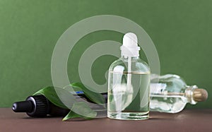 Bottles with scented oil on a green background