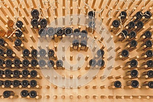 The bottles on the shelves of the wine cellar. Front view.