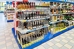 bottles of sparkling wine and prosecco and wines displayed on the shelves of supermarket