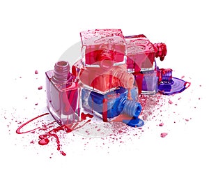 Bottles with spilled nail polish and crushed eye shadow