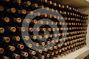 bottles stacked up in old wine cellar