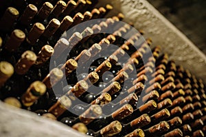 bottles stacked up in old wine cellar