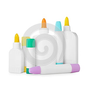 Bottles and sticks of glue on white background