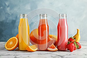 Bottles with tasty juices and ingredients