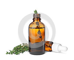 Bottles with thyme essential oil and fresh herb