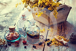 Bottles of tincture and dry healthy herbs, flower box.