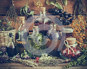 Bottles of tincture, potion, oil, healthy berries and herbs