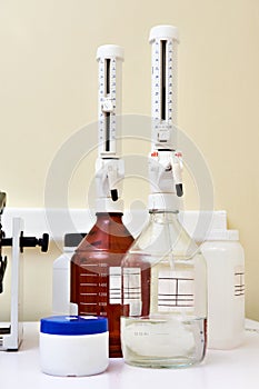 Bottles with top dispenser in biochemical laboratory