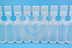 Bottles or vials with blue background medicine vaccination concept. photo