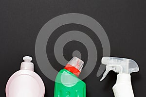 Bottles of washing and cleaning liquids on the black background