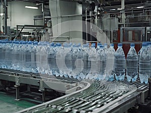 Bottles of water on conveyor belt in factory - generated by ai