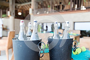 Bottles of water in ice bucket at hotel restaurant