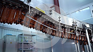 Bottling beverages on automatic conveyor line on factory in plastic bottles. Manufacturing of carbonated beverages, beer