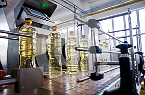 Bottling line of sunflower oil in bottles. Vegetable oil production plant.