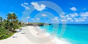 Bottom Bay, Barbados - Paradise beach on the Caribbean island of Barbados. Tropical coast with palms hanging over turquoise sea.