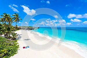 Bottom Bay, Barbados - Paradise beach on the Caribbean island of Barbados. Tropical coast with palms hanging over turquoise sea.