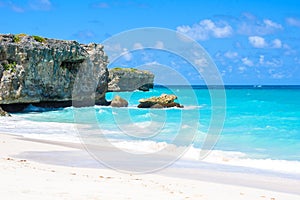 Bottom Bay, Barbados - Paradise beach on the Caribbean island of Barbados. Tropical coast with palms hanging over turquoise sea.