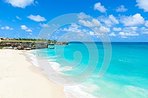 Bottom Bay, Barbados - Paradise beach on the Caribbean island of Barbados. Tropical coast with palms hanging over turquoise sea.