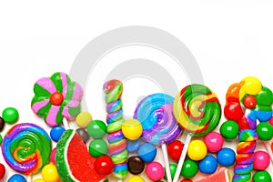 Bottom border of colorful candies over white