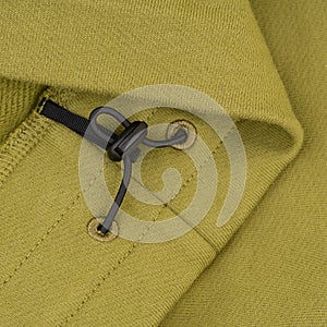 Bottom with drawstrings of green sweatshirt