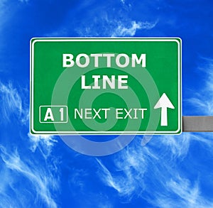 BOTTOM LINE road sign against clear blue sky