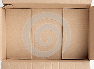 Bottom of open empty brown cardboard box, top view
