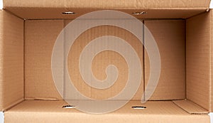 Bottom of open empty brown cardboard box, top view