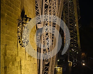 Bottom part of the Dom Luis I Bridge at night in Porto, Portugal