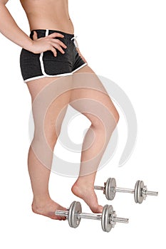 The bottom part of a woman with some dumbbells