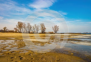 Bottom sand during discharge of water on the Dnieper river, Cherkasy, Ukraine at early spring day