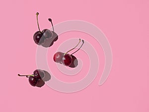 Bottom shaped cherries on bright pink background