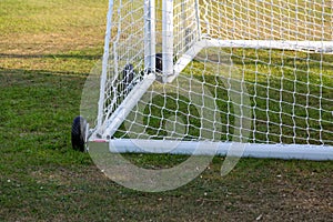 The bottom of some moveable football goal posts and nets