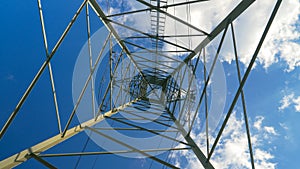 BOTTOM UP: Metal construction of an electricity pylon soars into the clear sky.