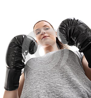 Bottom up view of a beautiful young woman with boxing gloves