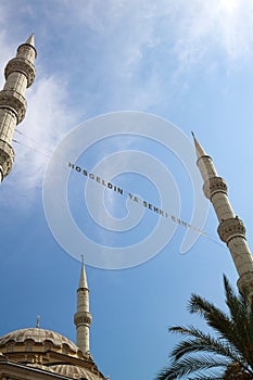 bottom-up view of the inscription of Hosgeldin ya sehri Ramazan between the minarets. Translation from turkish: Welcoming Ramadan