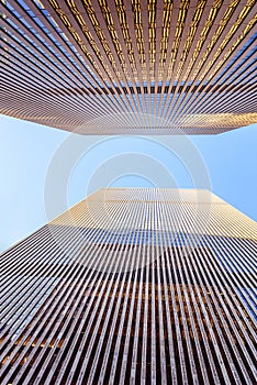 Bottom up view of modern skyscrapers with a blue sky on the background