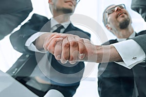 bottom view.businessmen shaking hands at the negotiating table