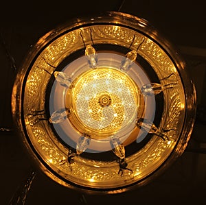 Bottom view at center of crystal chandelier lamp hang on white ceiling.