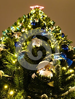 Bottom view of decorated Christmas tree outdoors