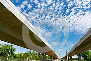 Bottom view of elevated concrete highway. Overpass concrete road. Strong structure of cement bridge. Concrete bridge engineering