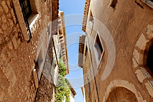 bottom view of facades of ancient stone buildings at old european town, Antibes, France