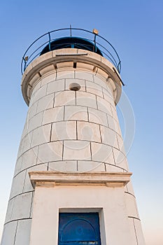 Bottom view of the Genoese lighthouse with a blue roof, from the pier