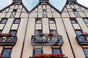 Bottom view of German-style houses with decorative beams and pots of flowers