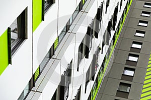 Bottom view of high new multiple dwelling of white, green and grey colors