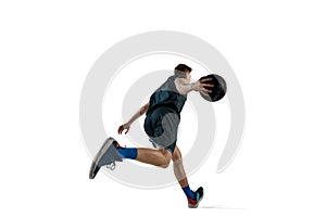 Bottom view image of young man, athlete running with ball, playing basketball isolated against white background