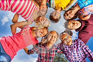 Bottom view of kids group standing in round shape