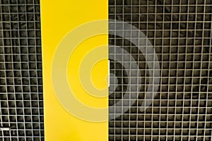 Bottom view of modern black ceilng with yellow panel. Interior design. Background