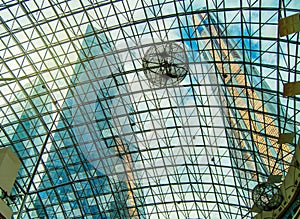 Bottom view of modern high-rise office buildings and cloudy sky through the glass roof of the shopping center, Moscow, Moscow city