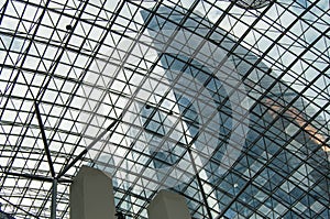 Bottom view of modern high-rise office buildings and cloudy sky through the glass roof of the shopping center, Moscow, Moscow city